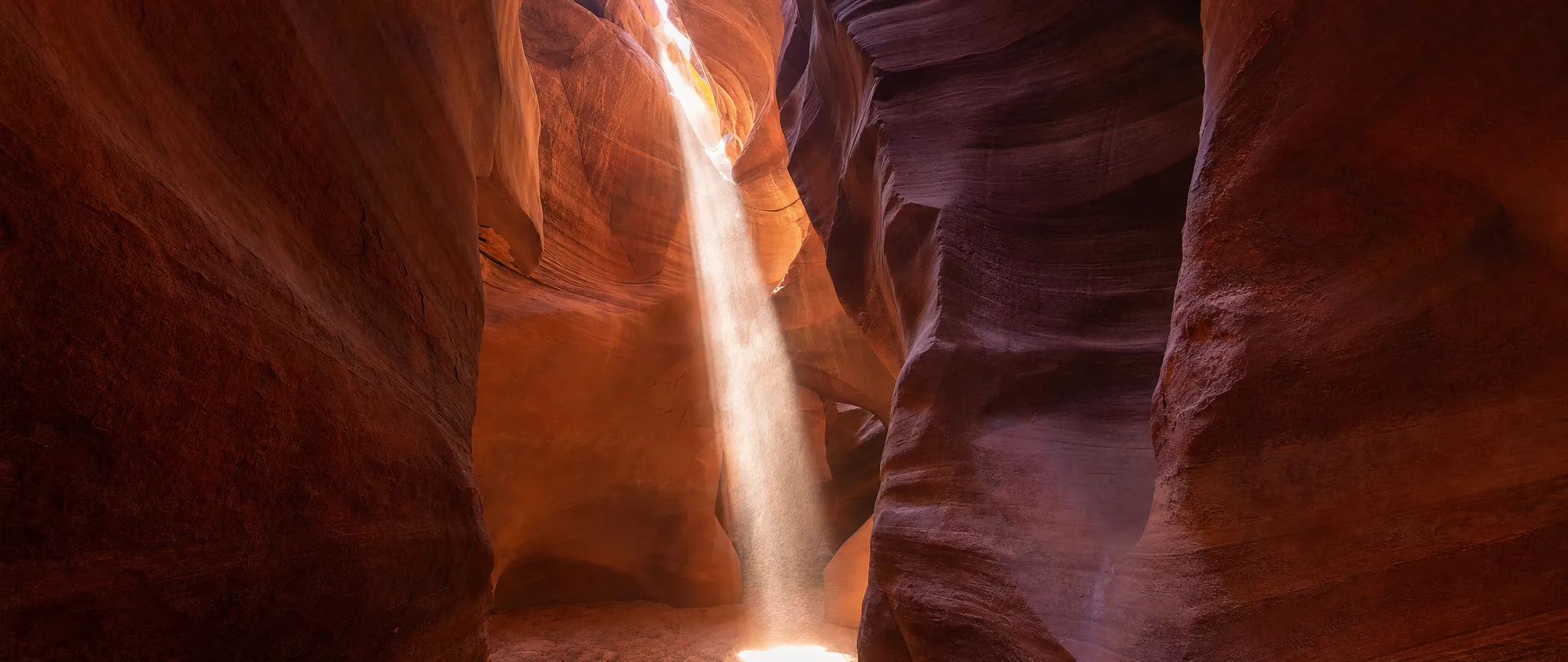 A beam of sunlight in a sandstone slot canyon