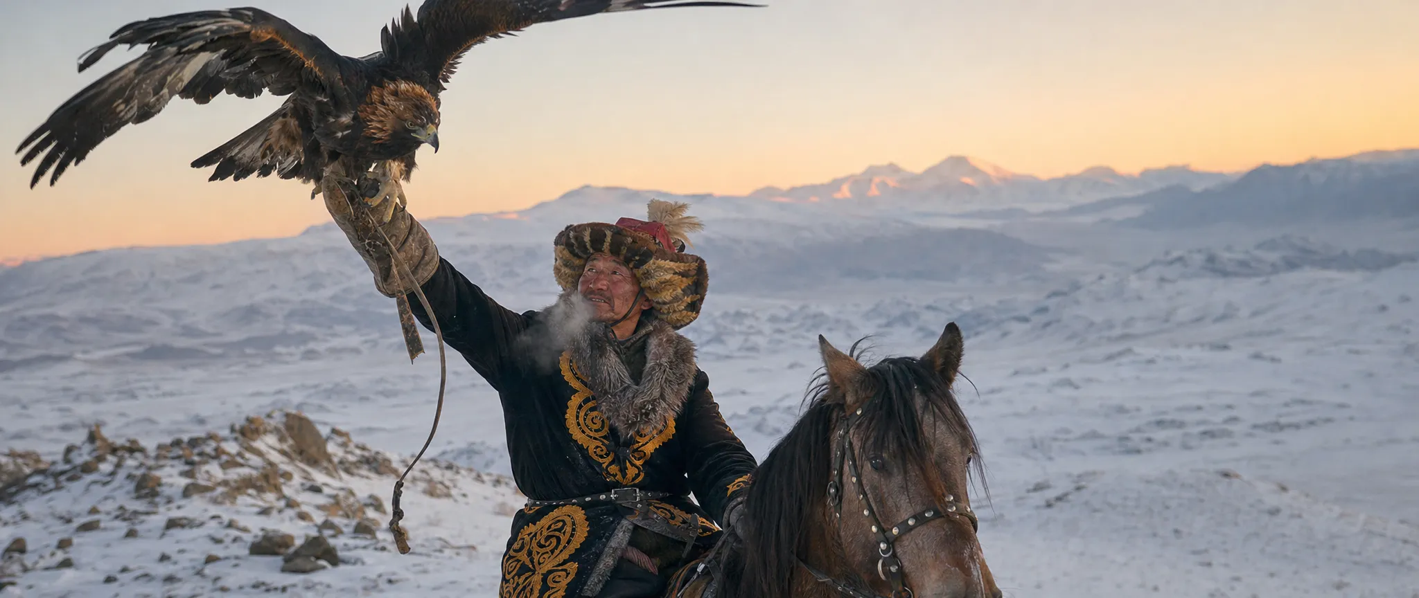An eagle hunter on horseback releasing a golden eagle in the snowy Altai