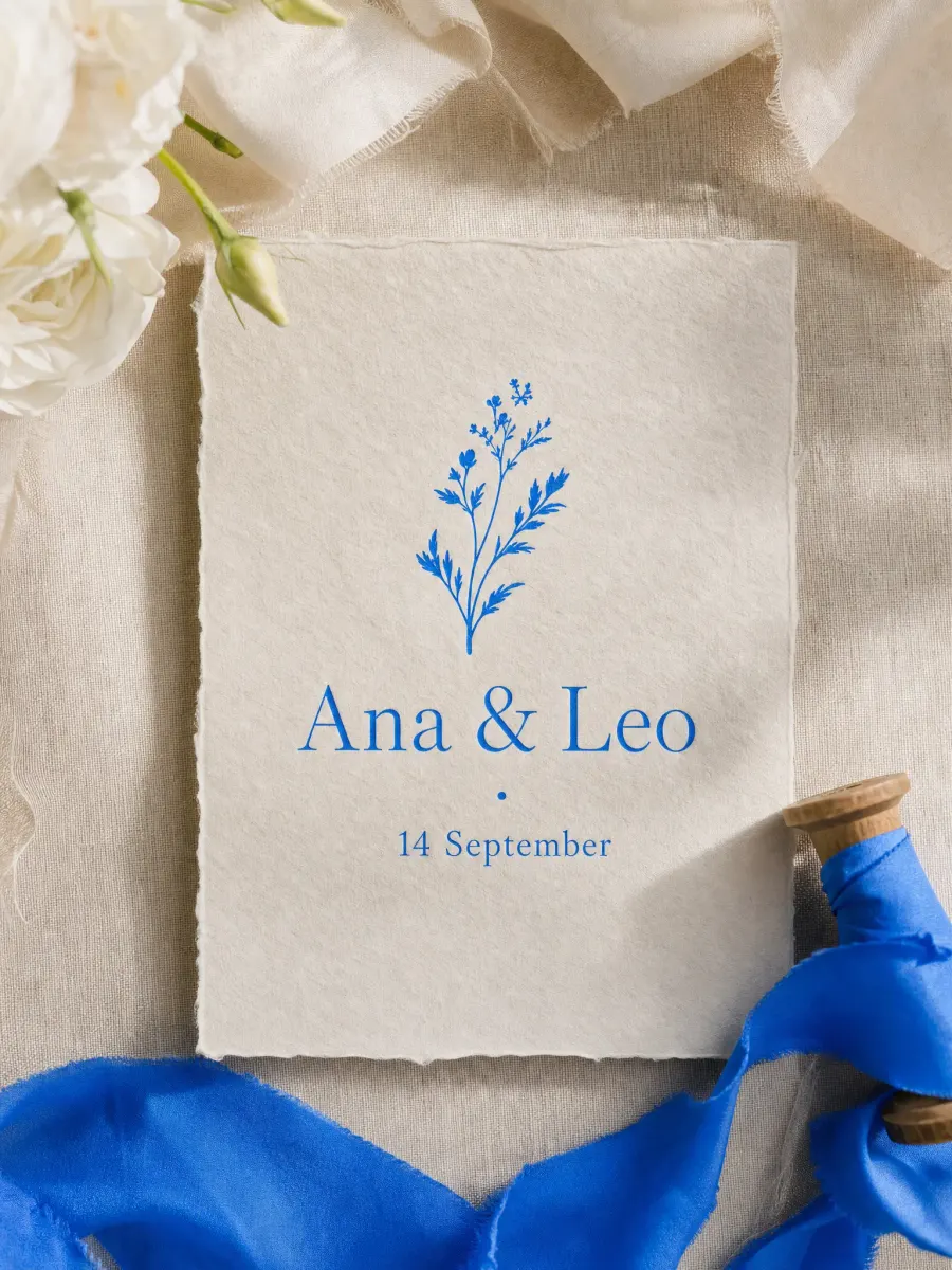 A wedding invitation card that reads "Ana & Leo · 14 September" on linen