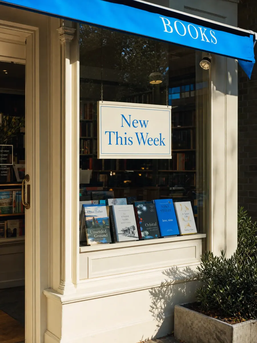 A bookshop window with a sign that reads "New This Week"
