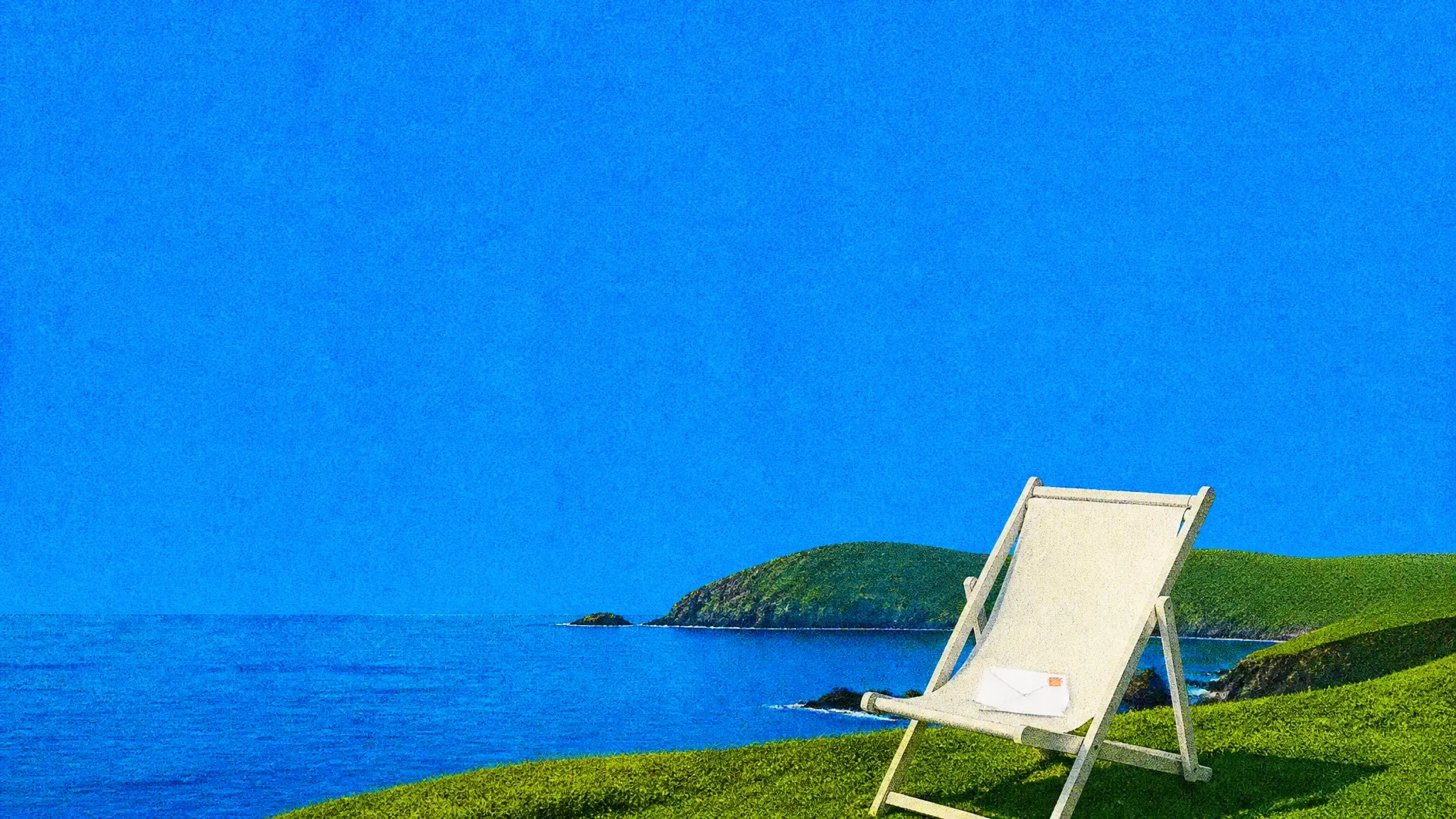 An empty deckchair with an envelope on its seat, on a green headland by the sea