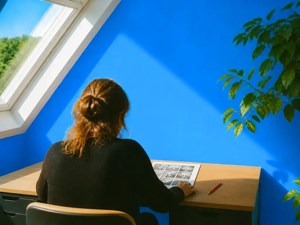 A writer reading a printed comic page