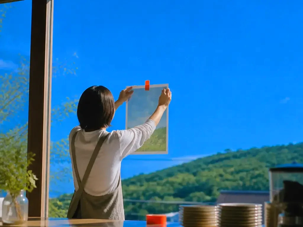 A café owner taping a flyer to the window