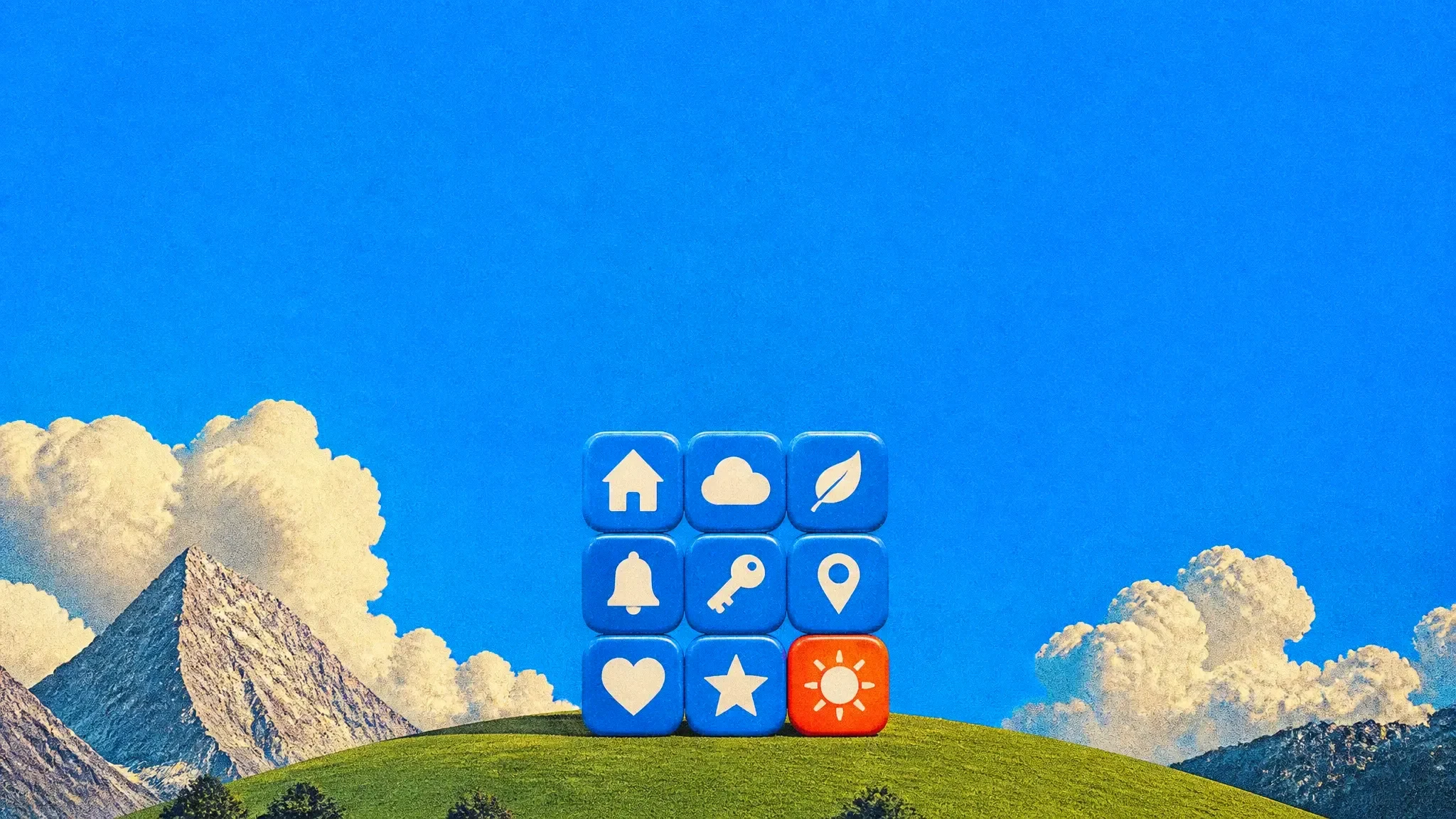 A grid of nine giant app icon tiles standing on a green hill