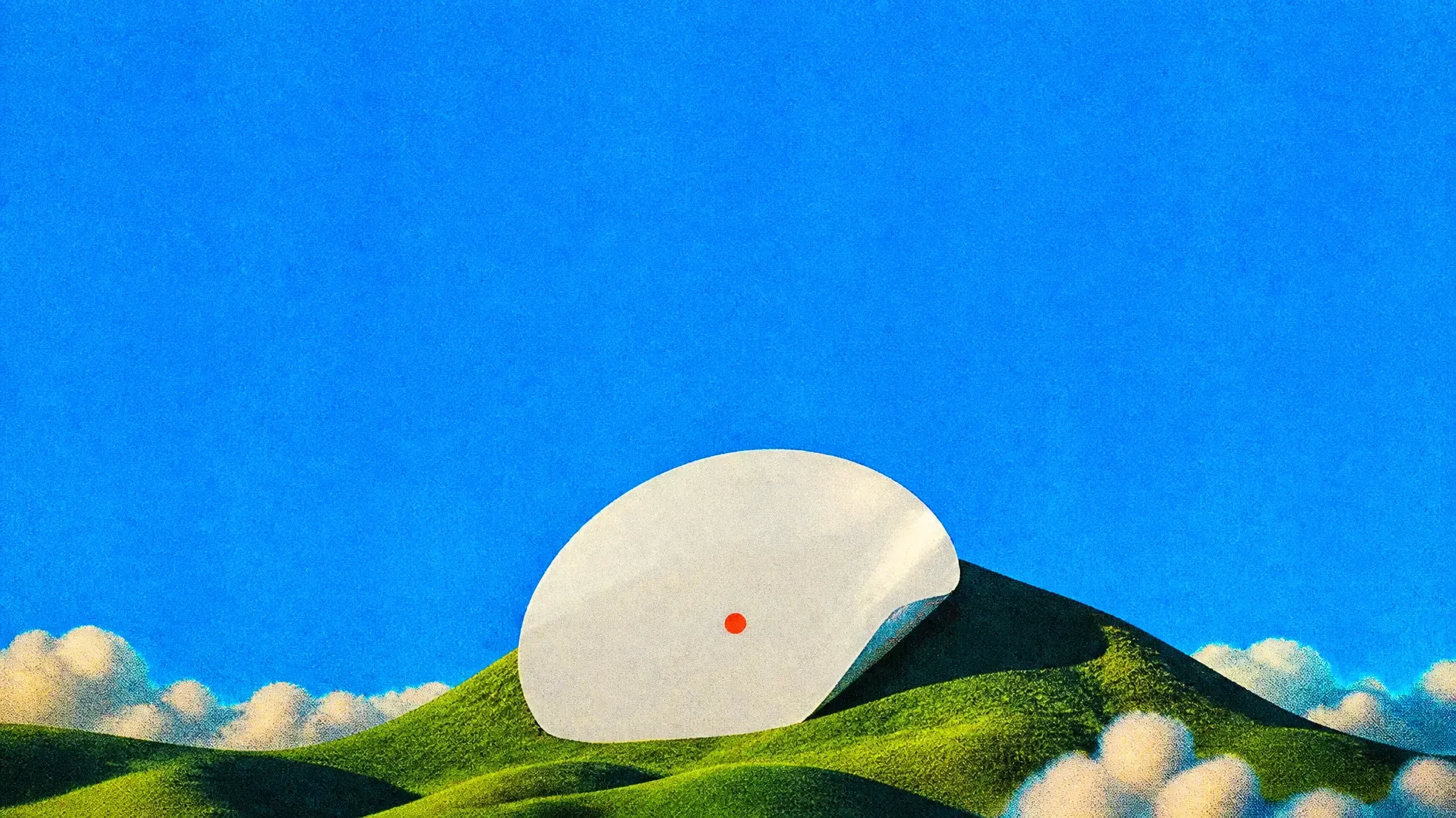 A giant white sticker peeling up on a green hill like a rising moon