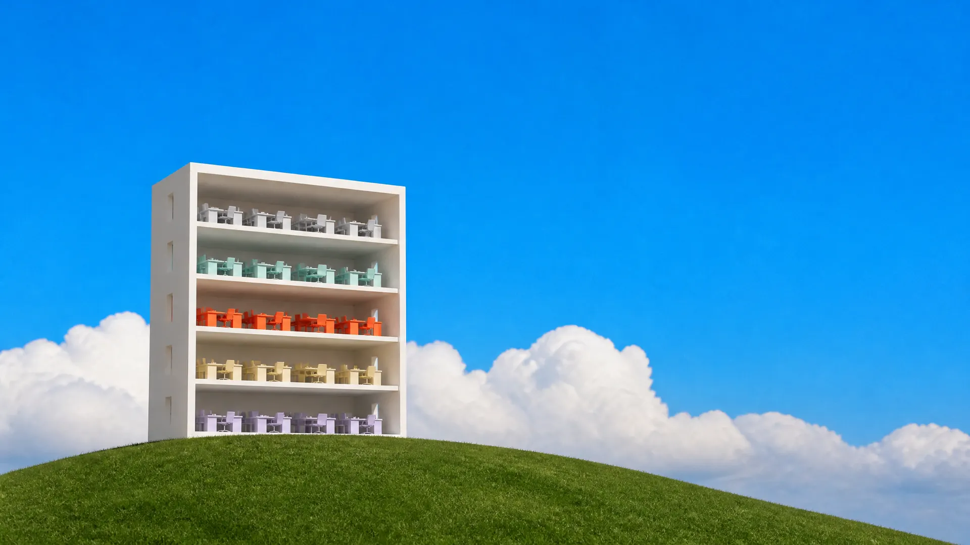 A white cutaway model of an office building on a hill, each floor of desks in a different colour, one floor orange.
