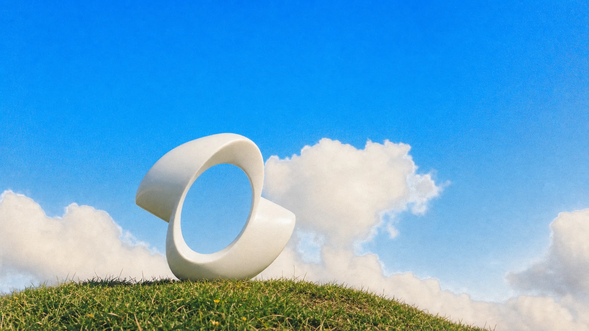 The Kling ribbon logo as a white sculpture on a grassy hilltop under a blue sky