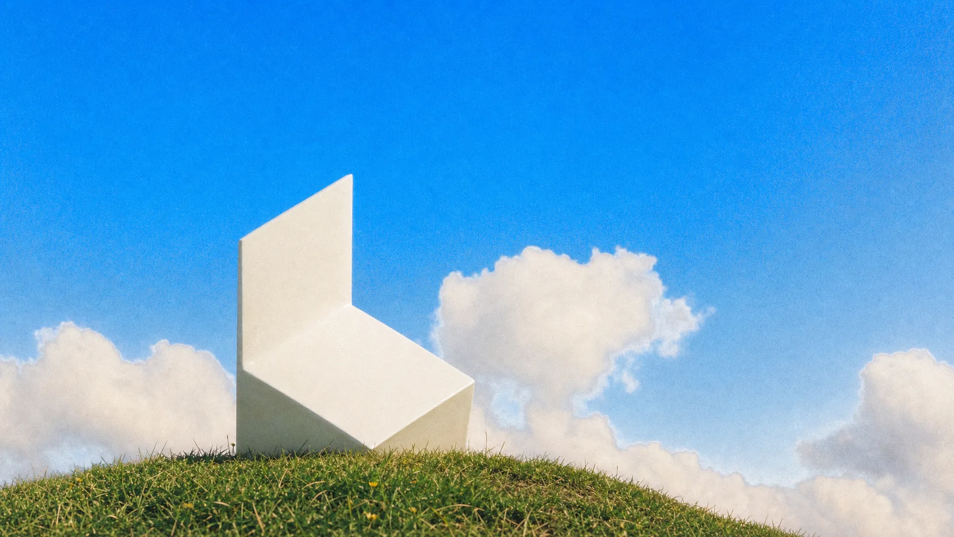 The Luma folded logo as a white sculpture on a grassy hilltop under a blue sky