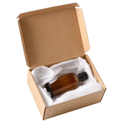 An open kraft product box with an amber bottle in tissue paper