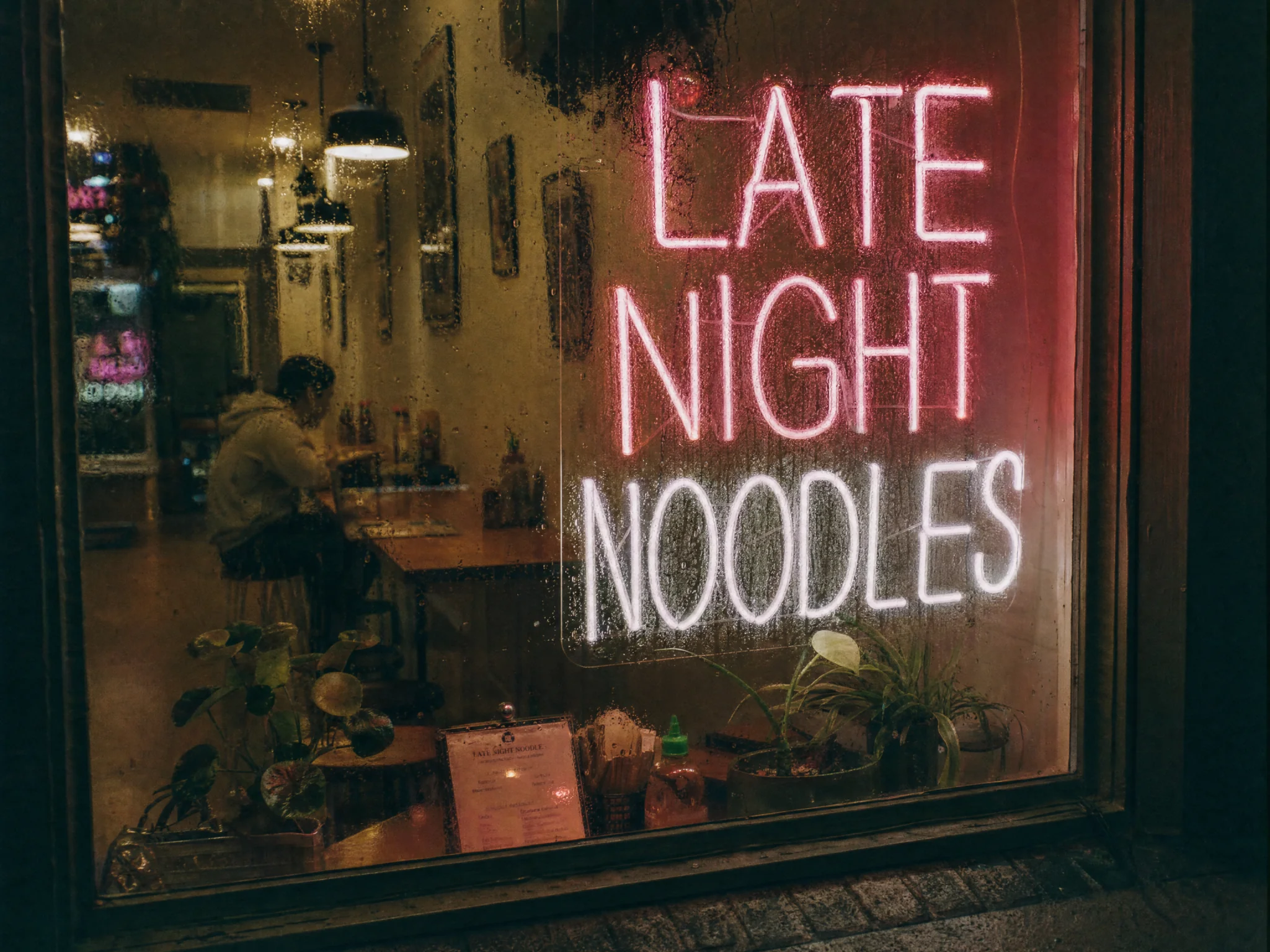 A neon sign reading Late Night Noodles