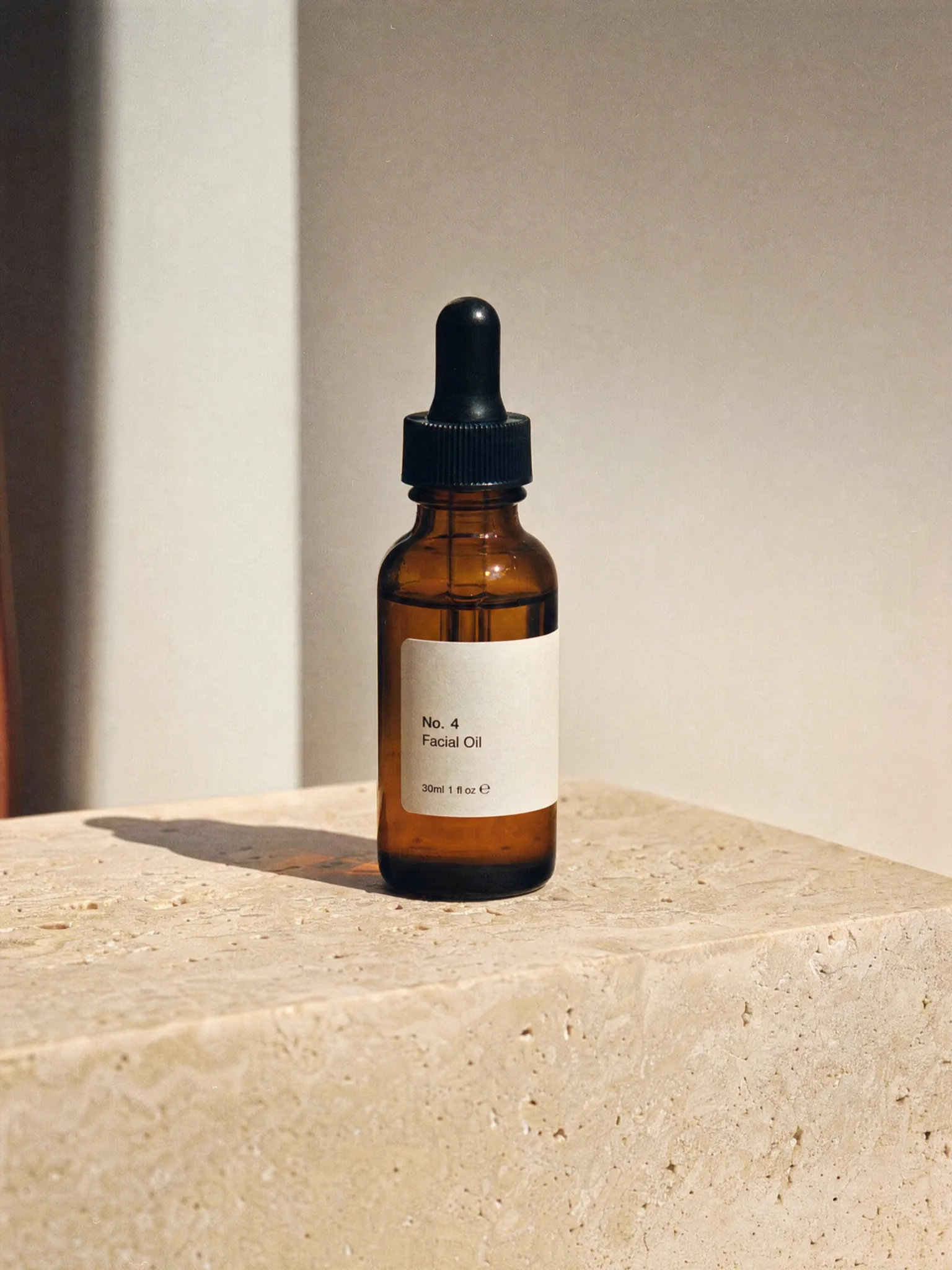 A skincare bottle labelled No. 4 on travertine