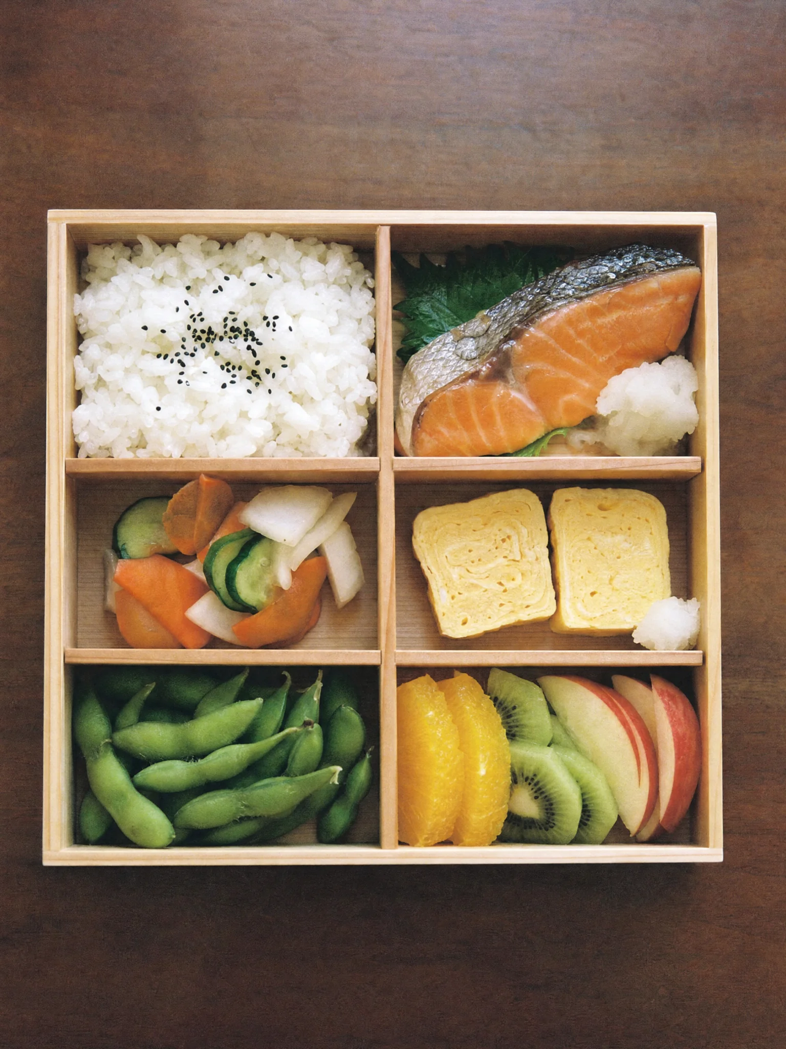 A bento lunch box with six compartments, top-down