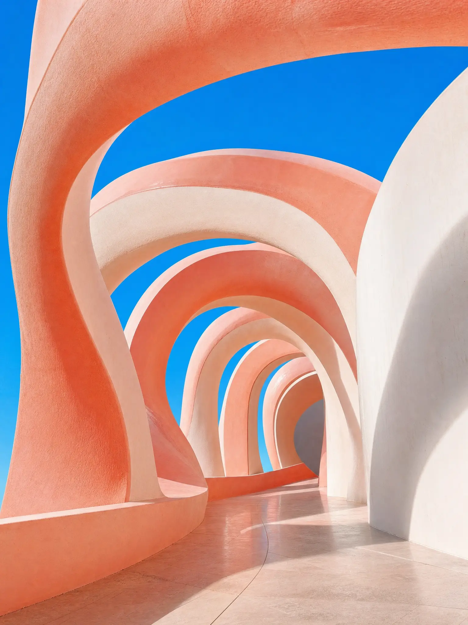 Nested coral and ivory arches against an azure sky