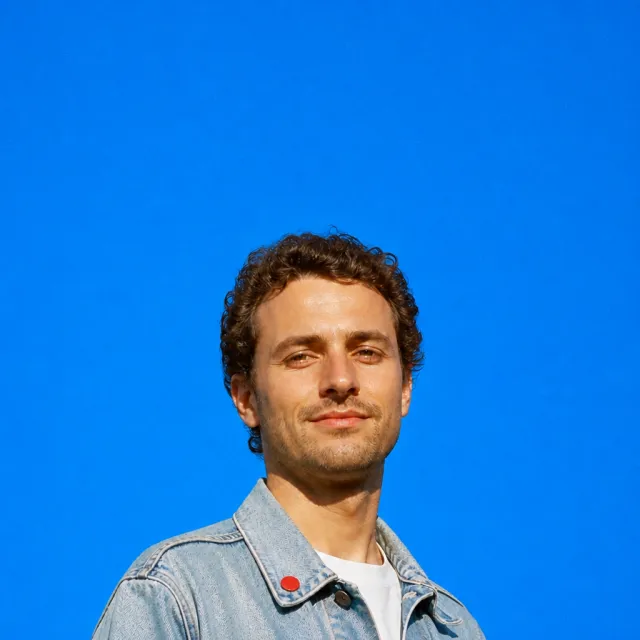 The same portrait on a blue studio backdrop
