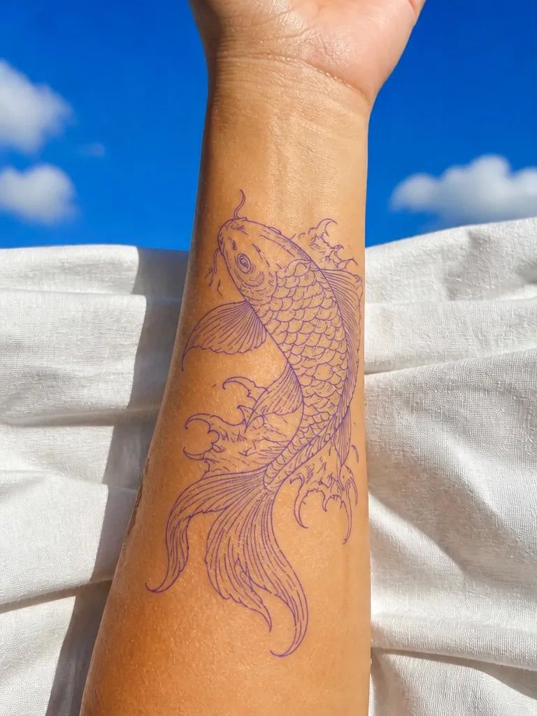 A koi fish tattoo stencil on a forearm