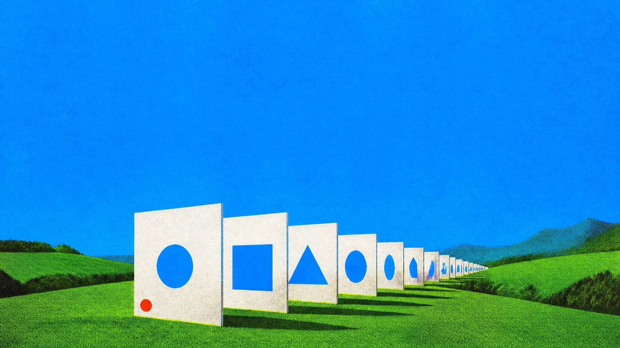 A row of large slides standing across a green meadow